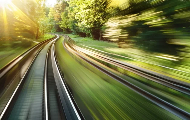 a sleek, futuristic train speeding through a lush green landscape.