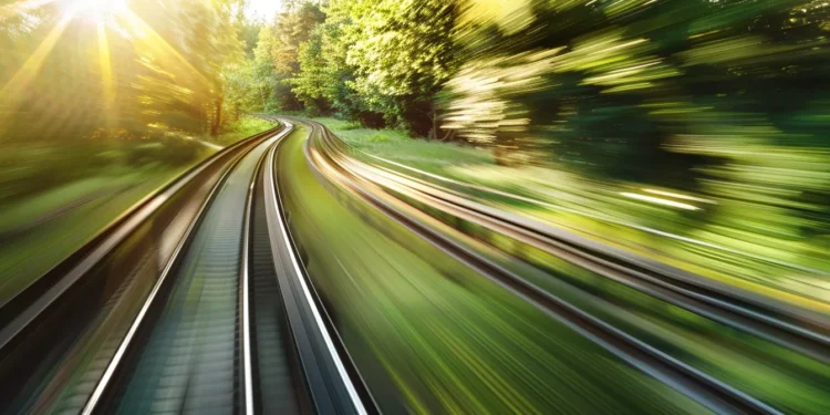 a sleek, futuristic train speeding through a lush green landscape.