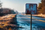 a road sign with the text "1 mile" displayed prominently.