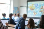 a group of travelers in a classroom receiving a comprehensive and interactive defensive foreign travel briefing.